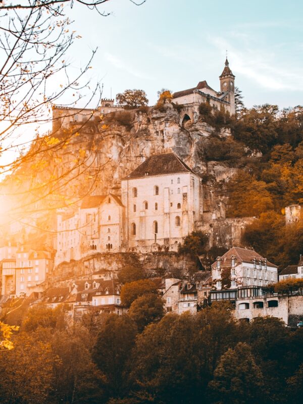 white concrete buildings and houses at a hill during daytime